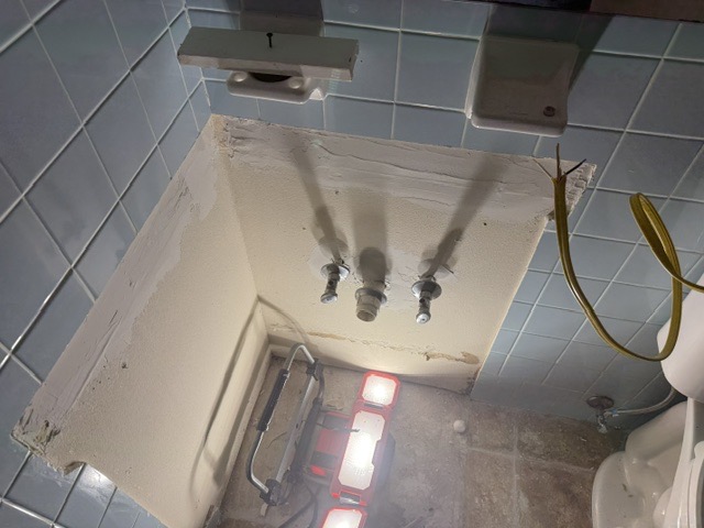 Bathroom plumbing rough-in and tile repair